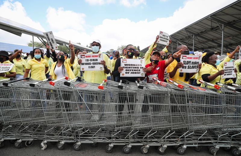 Workers go on strike outside a Walmart-led Massmart Holdings owned Makro store in Johannesburg