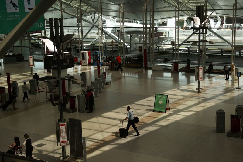 FILE PHOTO: A traveller walks through a domestic terminal at Sydney Airport in Sydney