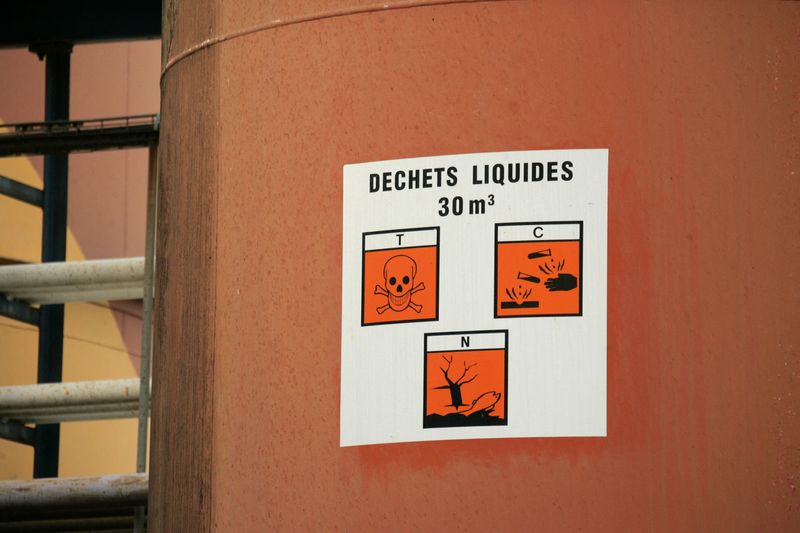 FILE PHOTO: Warning signs are seen on a tank at the Tredi Seche toxic waste treatment plant, in Salaise-sur-Sanne