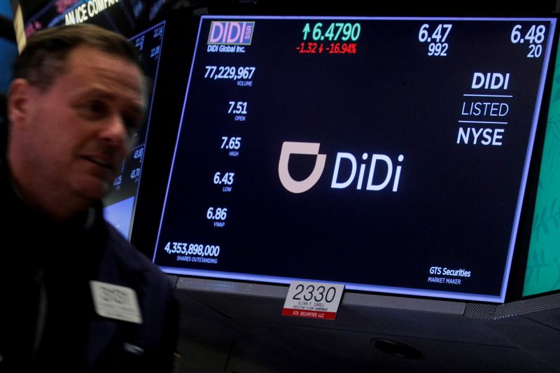 A screen displays trading information for ride-hailing giant Didi Global on the floor of the NYSE in New York