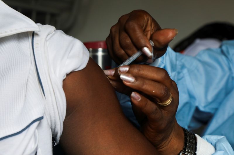 FILE PHOTO: A man receives a vaccine against the coronavirus disease (COVID-19) at a mobile vaccination center in Abidjan, Ivory Coast