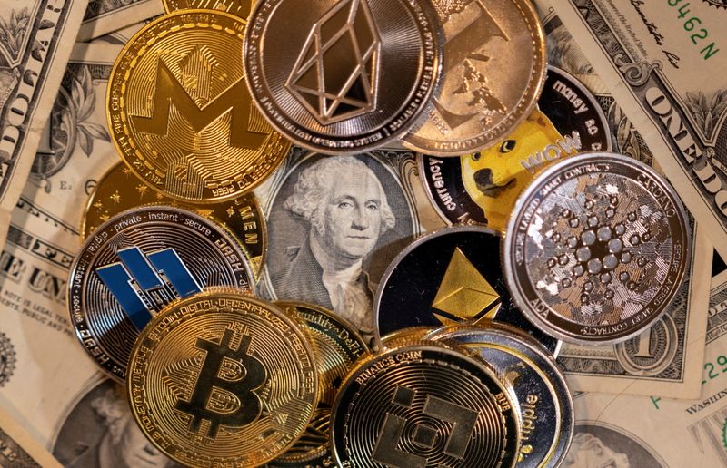 FILE PHOTO: Illustration shows representations of virtual cryptocurrencies on U.S. dollar banknotes
