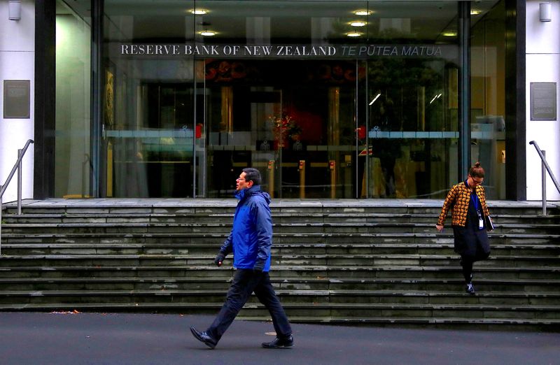 FILE PHOTO: Pedestrians walk near the main entrance to the Reserve Bank of New Zealand located in central Wellington, New Zealand