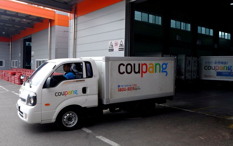 FILE PHOTO: Delivery trucks for e-commerce retailer Coupang leave a distribution centre in Seoul