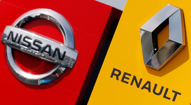 FILE PHOTO: The logos of car manufacturers Renault and Nissan are seen in front of dealerships of the companies in Reims