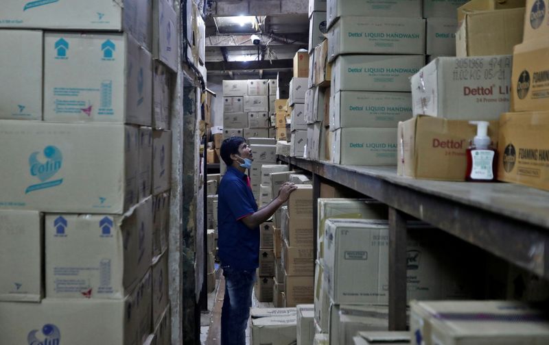 FILE PHOTO: A worker inspects boxes of Reckitt's Dettol handwash at a distributorÕs warehouse before loading them onto a truck for delivery to retailers in Mumbai