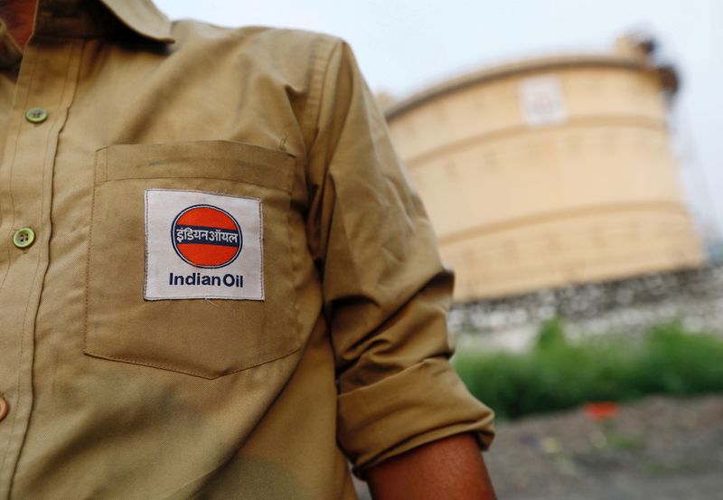 FILE PHOTO: An Indian Oil tanker driver waits outside a fuel depot in Mumbai