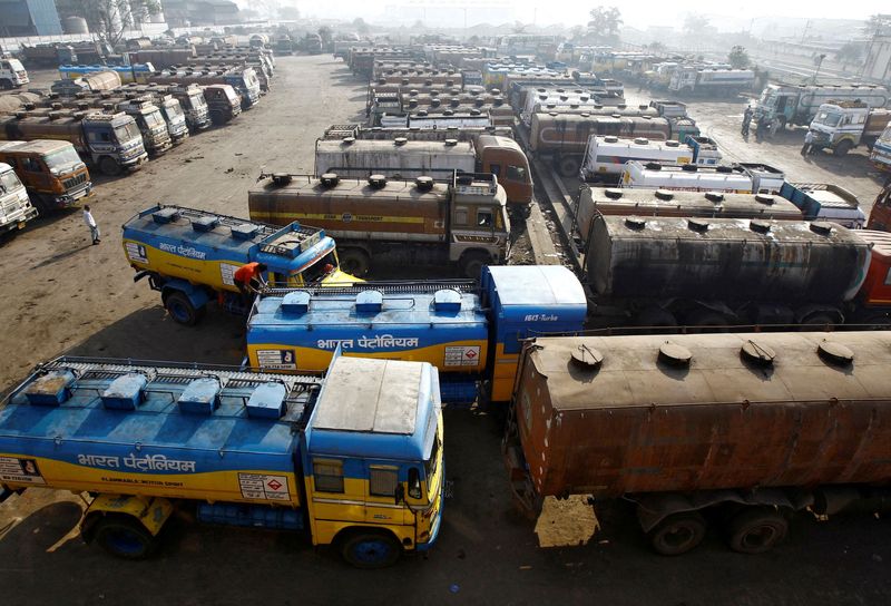 FILE PHOTO: FILE PHOTO: Oil tankers are seen parked at a yard outside a fuel depot on the outskirts of Kolkata