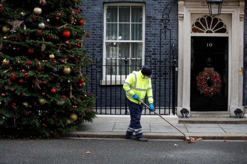 FILE PHOTO: Street cleaner works outside Downing Street in London