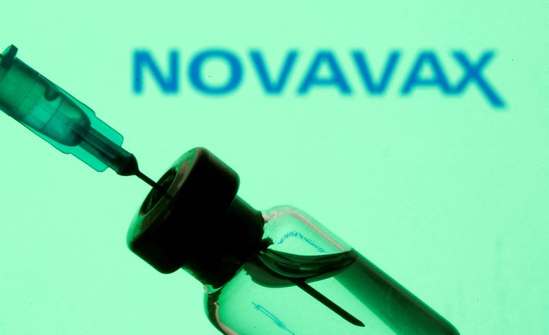 FILE PHOTO: Vial and sryinge are seen in front of displayed Novavax logo in this illustration