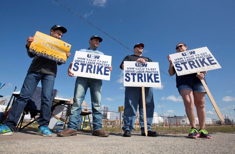 FILE PHOTO: Workers from the USW union walk a picket line outside the Lyondell-Basell refinery in Houston, Texas.