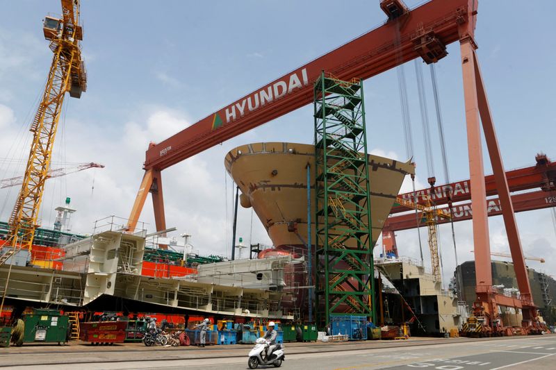 FILE PHOTO: Motorcyclist rides in a shipyard of Hyundai Heavy Industries in Ulsan