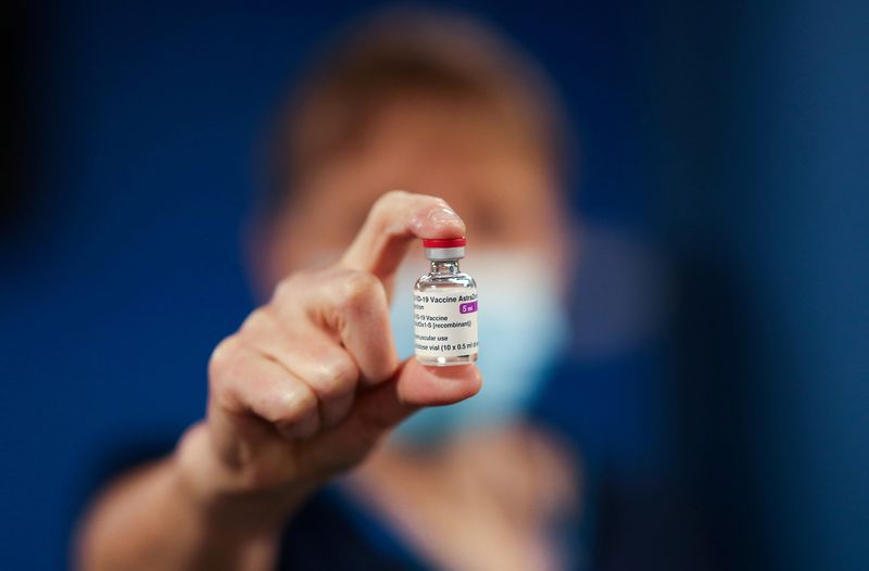 FILE PHOTO: A healthcare worker holds a vial of the AstraZeneca/Oxford University COVID-19 vaccine at the Pentland Medical Practice in Currie, Scotland