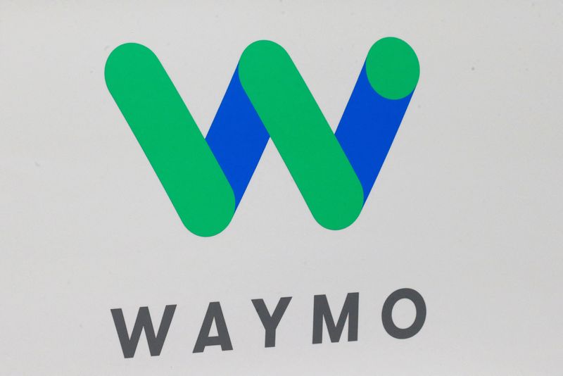 The Waymo logo is displayed during the company's unveil of a self-driving Chrysler Pacifica minivan during the North American International Auto Show in Detroit