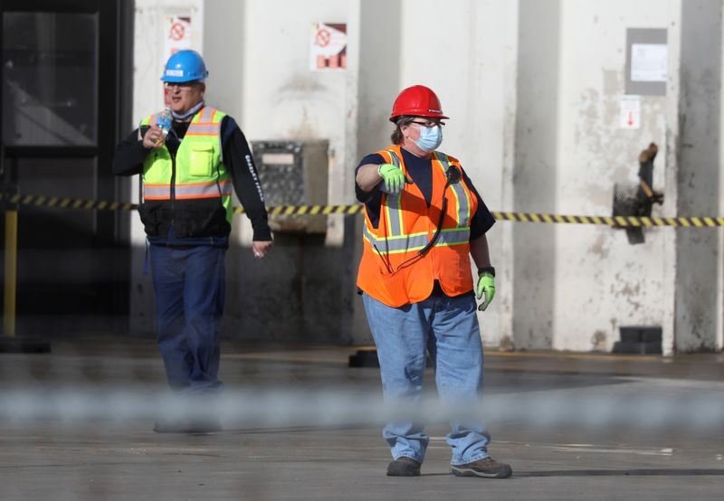FILE PHOTO: Employees wear face masks at the JBS USA meat packing plant in Greeley