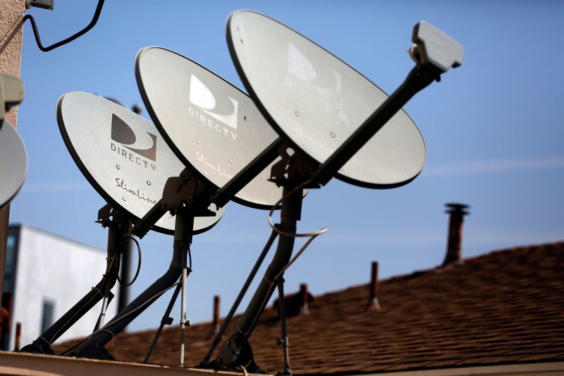 FILE PHOTO: DirecTV satellite dishes are seen on an apartment roof in Los Angeles
