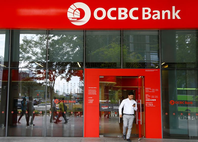 FILE PHOTO: A man walks out of an OCBC Bank branch in Singapore