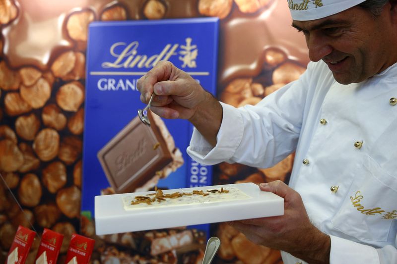 A Maitre Chocolatier of Swiss chocolatier Lindt & Spruengli prepares a chocolate after the annual news conference in Kilchberg