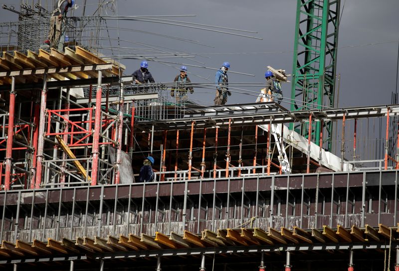 Workers are seen in a building undergoing construction at Mexico City