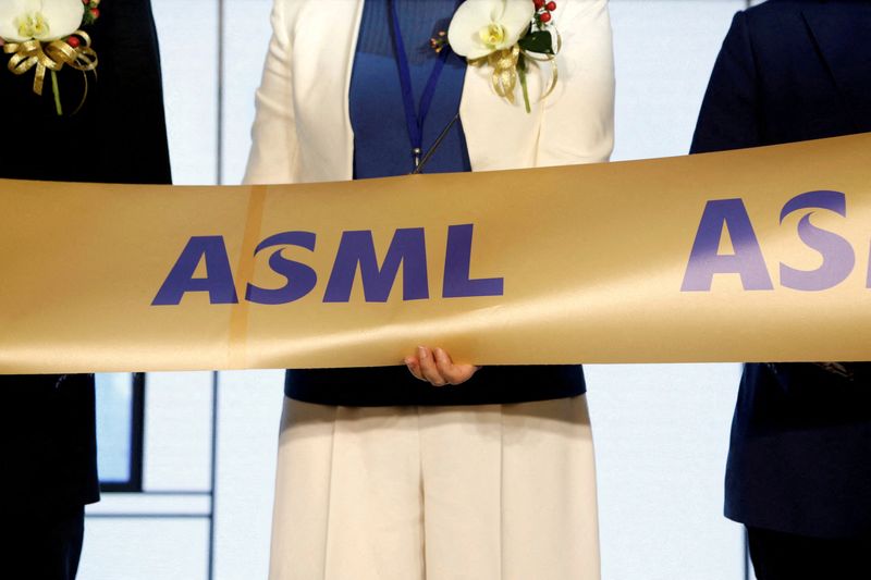 FILE PHOTO: Company representatives and government officials cut a ribbon during the opening ceremony of the EUV training center at ASML Holding in Tainan