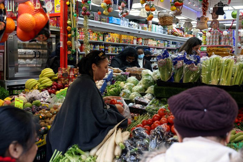 FILE PHOTO: People shop at a supermarket amid the coronavirus disease (COVID-19) outbreak, in London