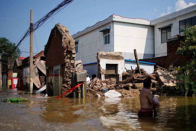 FILE PHOTO: Flooded houses are seen at a village following heavy rainfall in Xinxiang