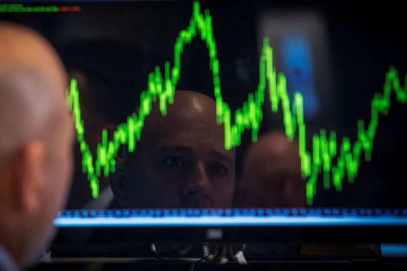 FILE PHOTO: A trader watches his chart while working on the floor of the New York Stock Exchange