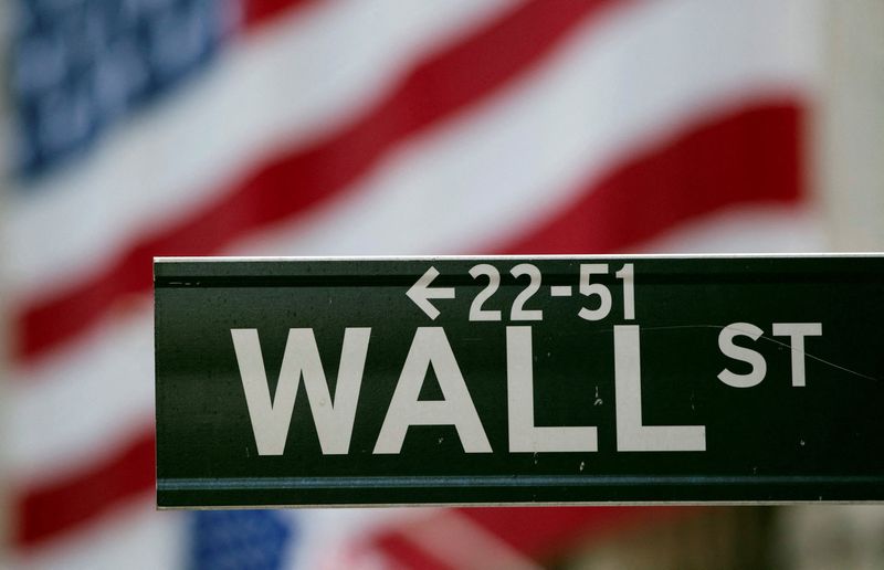 FILE PHOTO: A Wall Street sign hangs on a signpost in front of the New York Stock Exchange