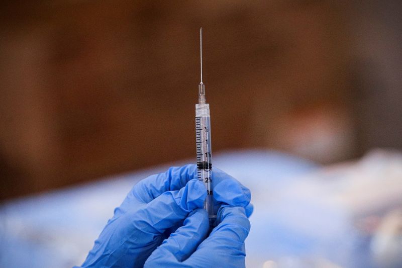FILE PHOTO: A syringe is filled with a dose of Pfizer's coronavirus disease (COVID-19) vaccine  at a pop-up community vaccination center in Valley Stream, New York