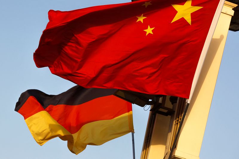 FILE PHOTO: German and Chinese national flags fly in Tiananmen Square in Beijing