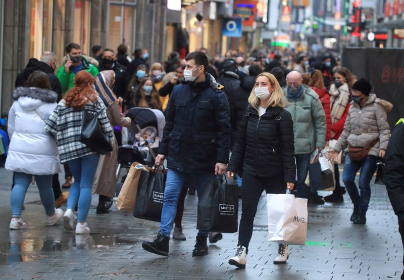 FILE PHOTO: Christmas shoppers wear masks and fill Cologne's main shopping street Hohe Strasse (High Street) during the coronavirus disease (COVID-19) pandemic in Cologne
