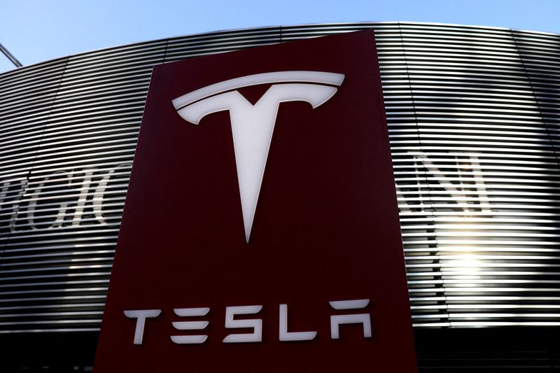 FILE PHOTO: Logo of the electric vehicle maker Tesla is seen near a shopping complex in Beijing