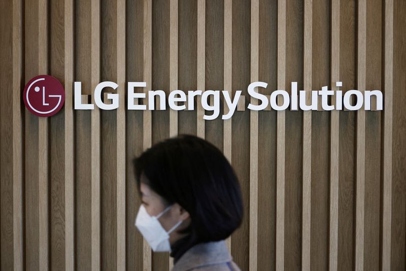 FILE PHOTO: An employee walks past the logo of LG Energy Solution at its office building in Seoul