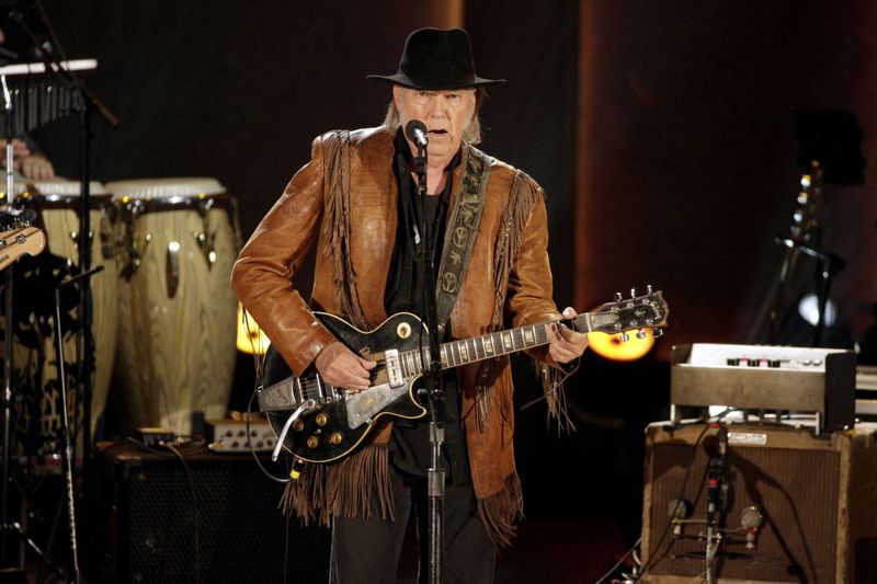 FILE PHOTO: Singer/songwriter Neil Young performs during a concert honoring singer/songwriter Willie Nelson, recipient of the Library of Congress' Gershwin Prize for Popular Song, in Washington
