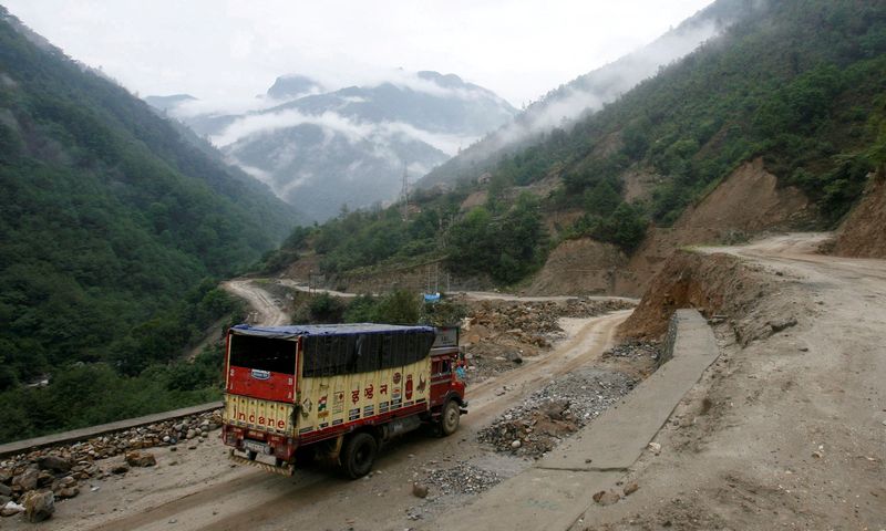 FILE PHOTO: A delivery truck drives along India's Tezpur-Tawang highway that runs to the Chinese border, in the northeastern Indian state of Arunachal Pradesh