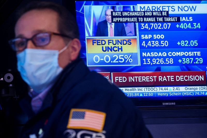 Una pantalla muestra el anuncio de tasas de la Fed mientras un operador especialista trabaja en su puesto en la Bolsa de Valores de Nueva York (NYSE) en la Ciudad de Nueva York