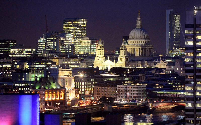 FILE PHOTO: St Paul's Cathedral and areas of the financial district of the City of London are seen at dusk