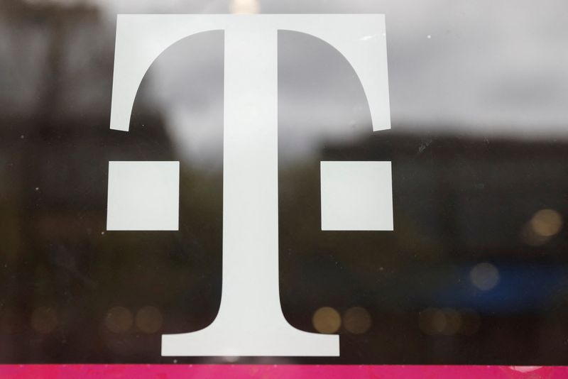 FILE PHOTO: A T-Mobile logo is seen on the storefront door of a store in Manhattan