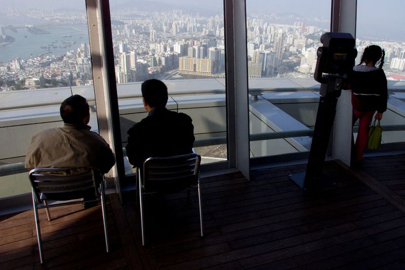 FILE PHOTO: VISITORS OBSERVE AN OVERVIEW FROM MACAU TOWER.