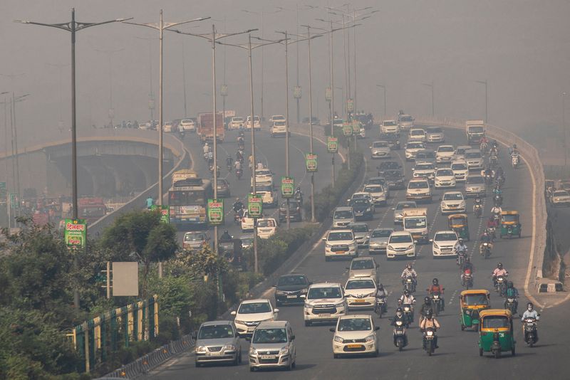 FILE PHOTO: Traffic moves on a smoggy morning in New Delhi