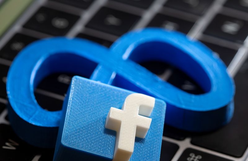 Imágenes impresas en 3D de los logotipos de la empresa matriz de Facebook, Meta Platforms, y de Facebook en el teclado de un ordenador portátil