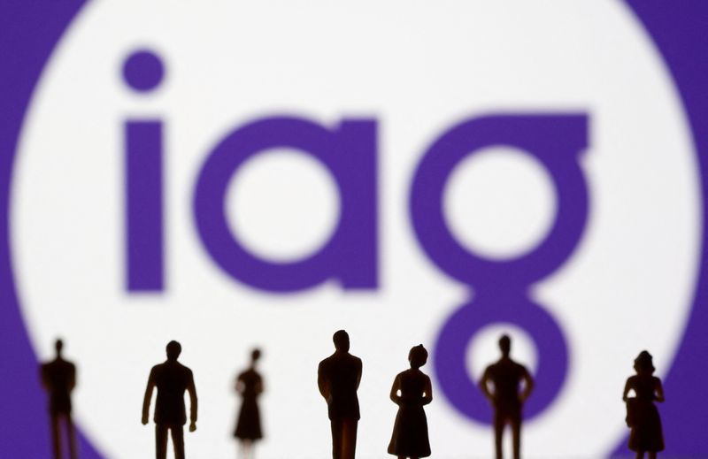FILE PHOTO: Small toy figures are seen in front of displayed IAG (Insurance Australia Group) logo in this illustration taken