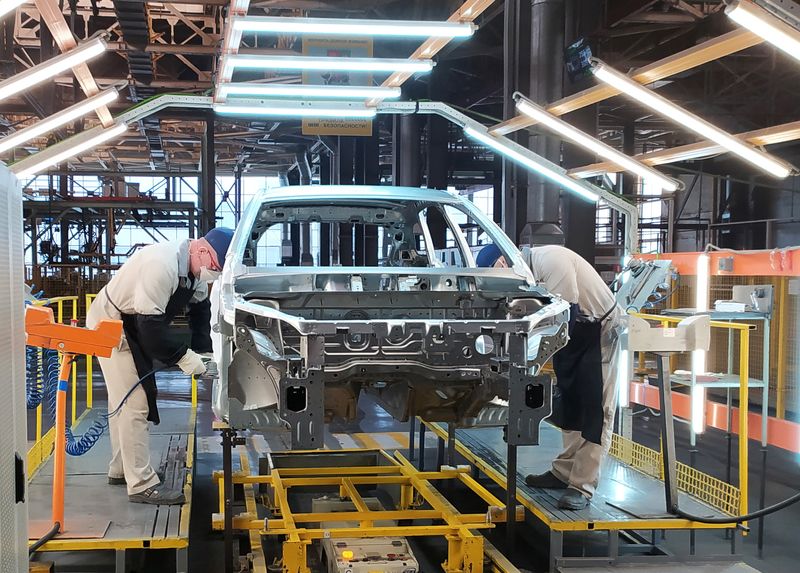 FILE PHOTO - Employees work at the assembly line of the LADA Izhevsk automobile plant in Izhevsk
