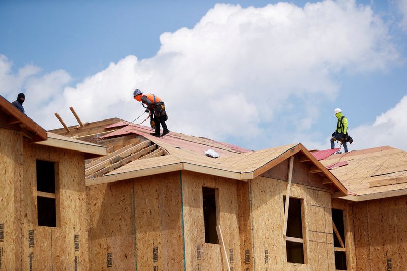 FILE PHOTO: Carpenters work on building new townhomes in Tampa, Florida