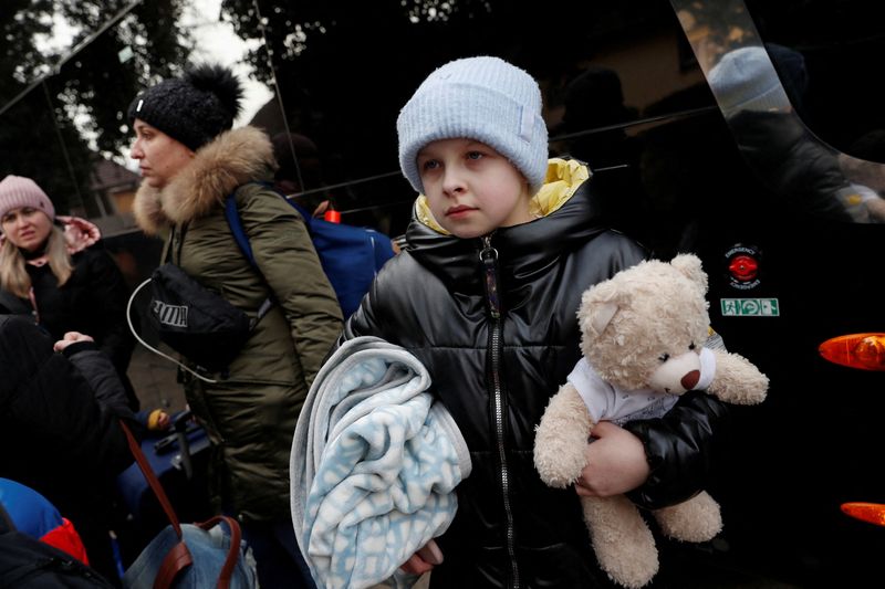 A child from Ukraine waits for a bus going to the Netherlands, after fleeing Russia's invasion of Ukraine, in Beregsurany, Hungary March 1, 2022