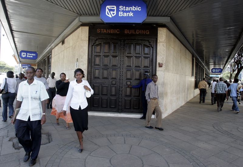 Kenyan city residents walk past Stanbic Bank in the capital Nairobi