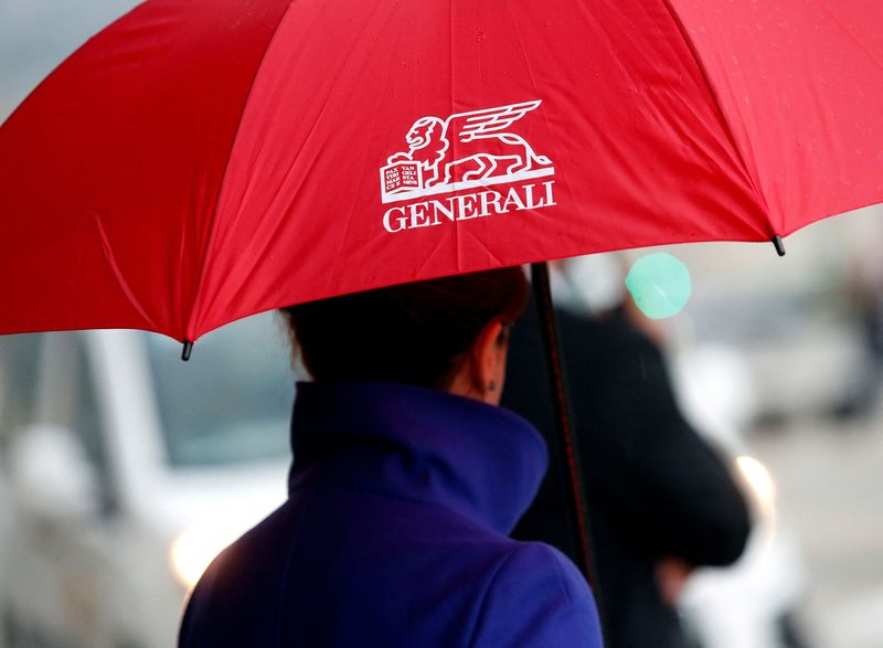 FILE PHOTO: A woman holds an umbrella as she arrives at the Italian insurance company Generali shareholders meeting in Trieste