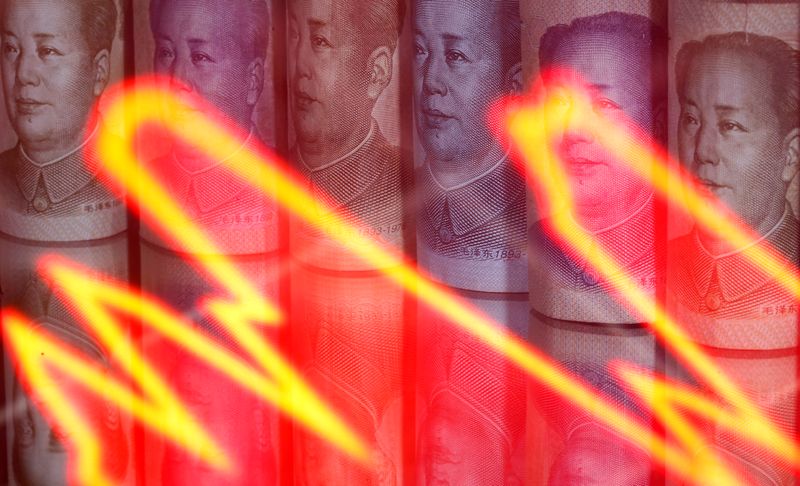FILE PHOTO: Chinese Yuan banknotes are seen behind illuminated stock graph in this illustration