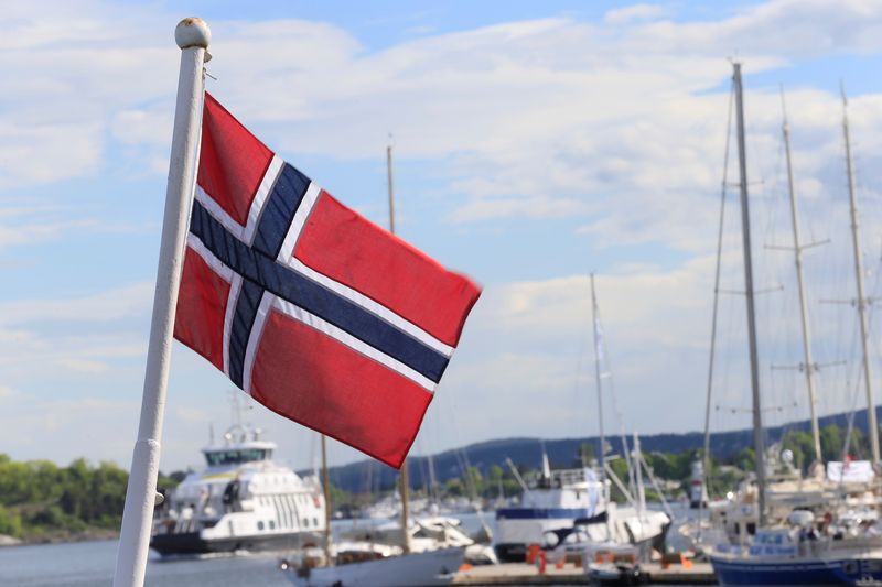 FILE PHOTO: Norwegian flag flutters on the boat at Aker Brygge in Oslo