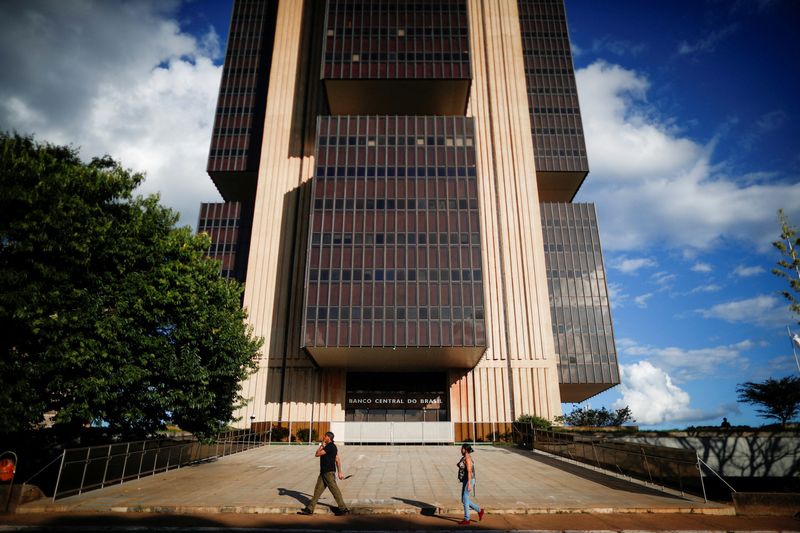FILE PHOTO: People walk in front the Central Bank headquarters building in Brasilia